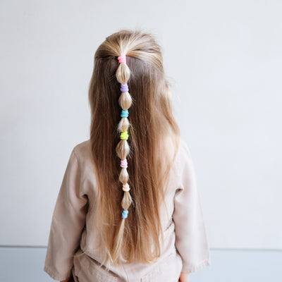 girl wearing Dreamland mini towelling ponies in a bobble pony hair style