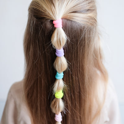 girl wearing Dreamland mini towelling ponies in a bobble pony hair style