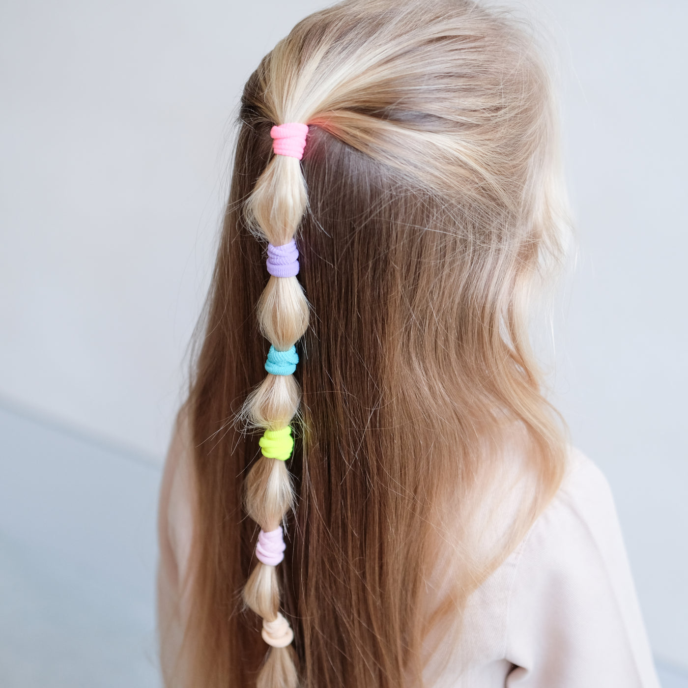 girl wearing Dreamland mini towelling ponies in a bobble pony hair style