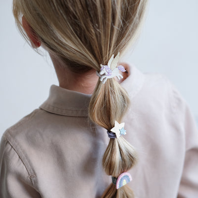 girl wearing Flying unicorn ponies in her hair