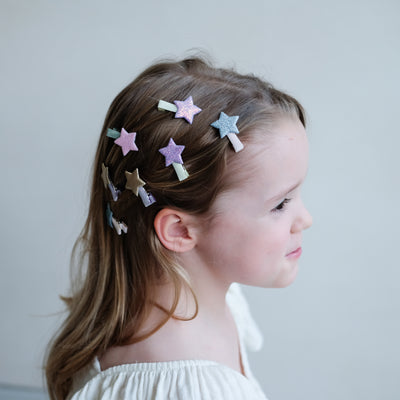 girl wearing lots of stella star mini clips on the side of her hair