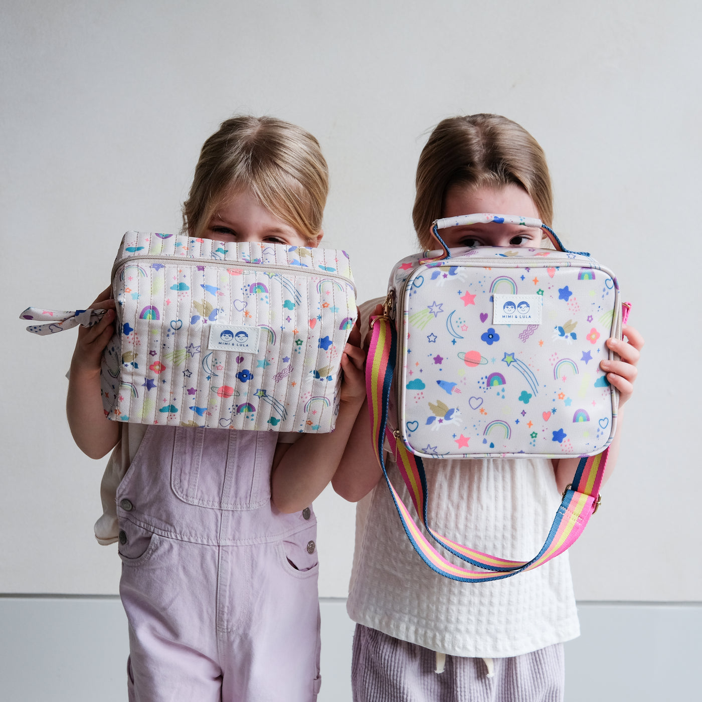 Hiding behind a brightly coloured unicorn print lunch bag and wash bag