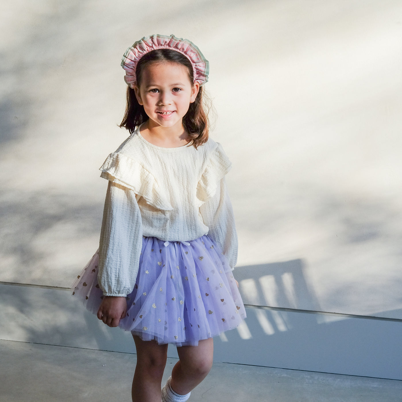 girl wearing stripe ruffle alice band and purple tutu