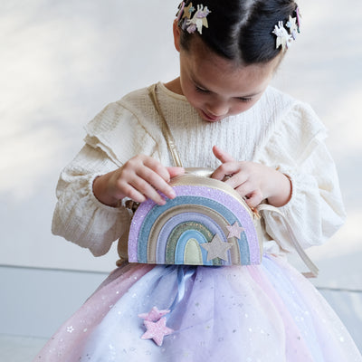 girl holding rainbow bag