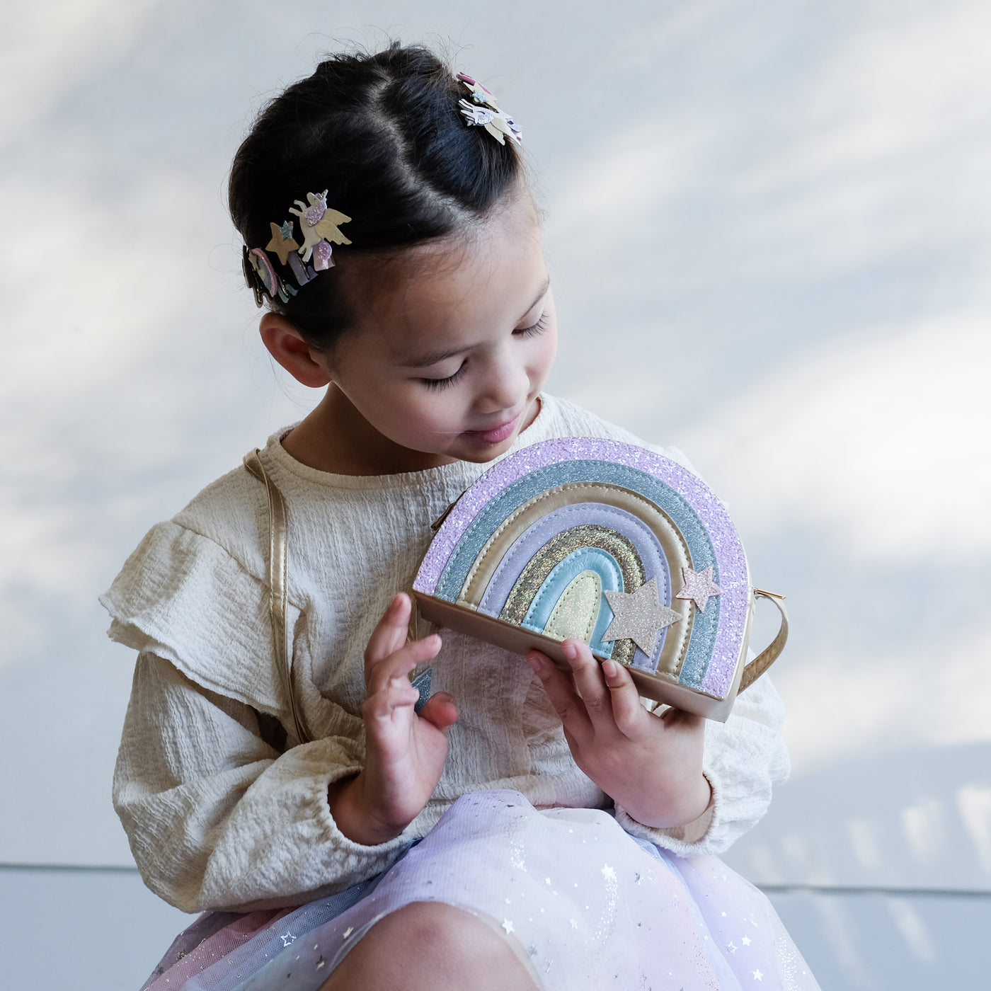 girl holding rainbow bag