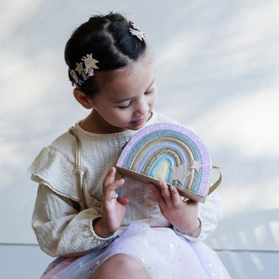 girl holding rainbow bag