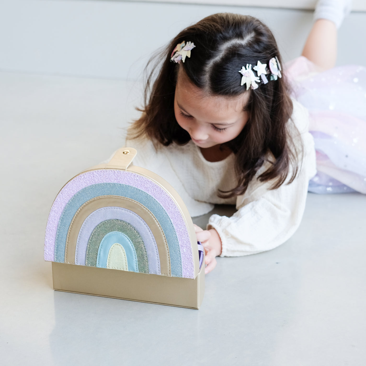 girl opening a rainbow jewellery box