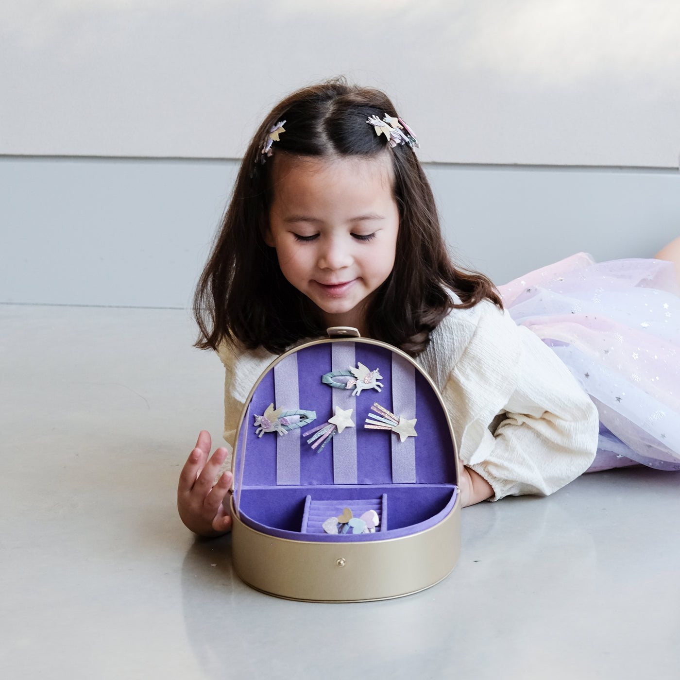 girl opening a rainbow jewellery box