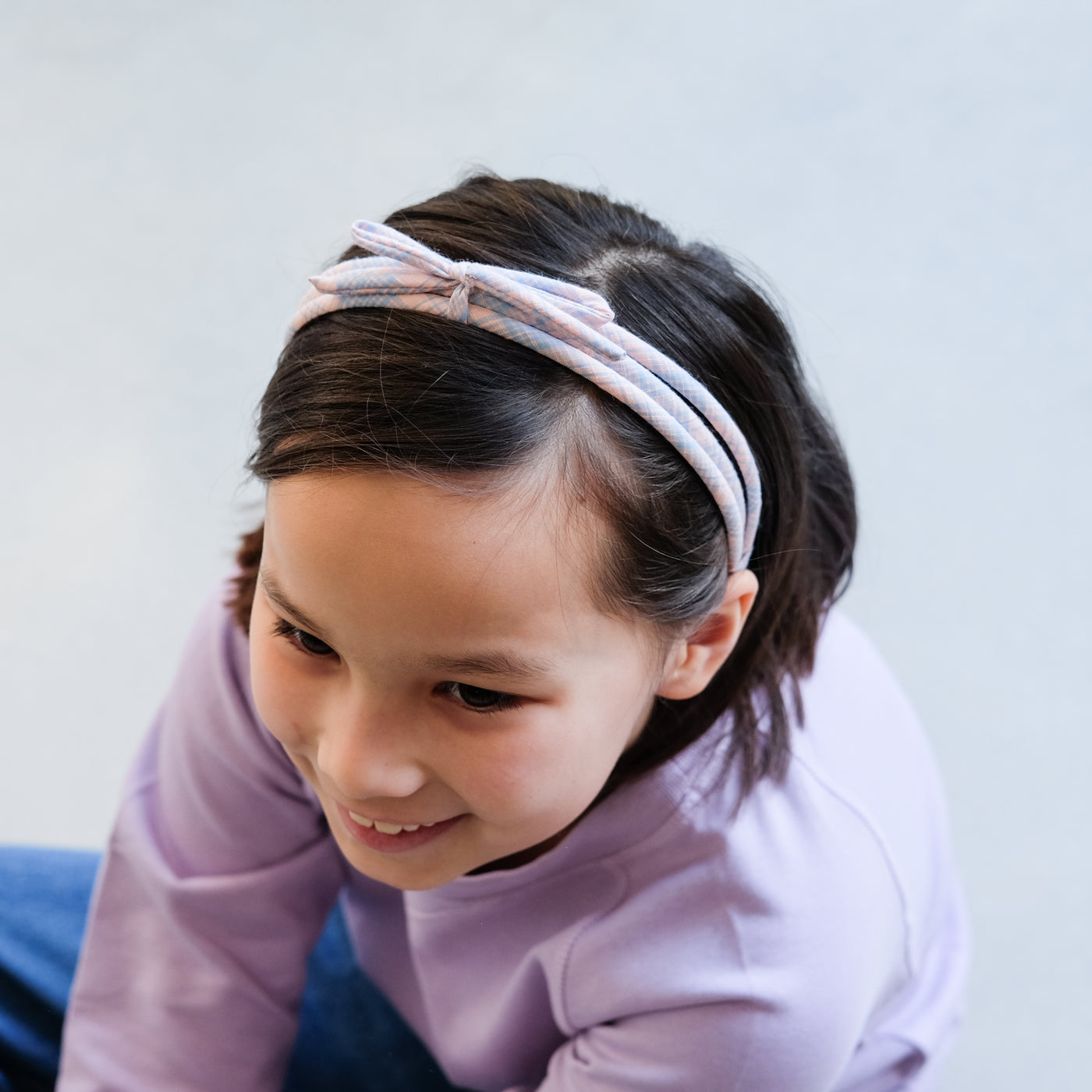 girl wearing checked triple alice band in hair