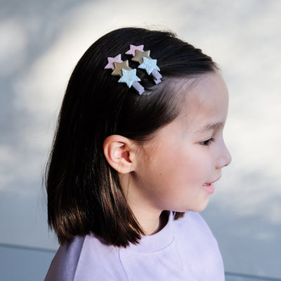 girl wearing star layered clips in pastel colours