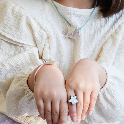 girl wearing flying unicorn jewellery set