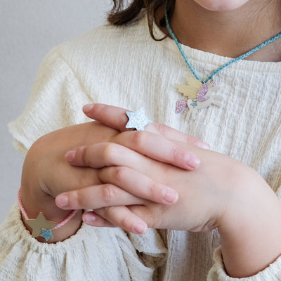 girl wearing flying unicorn jewellery set