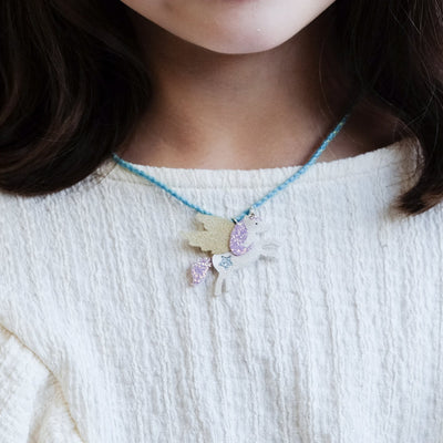 girl wearing flying unicorn jewellery set