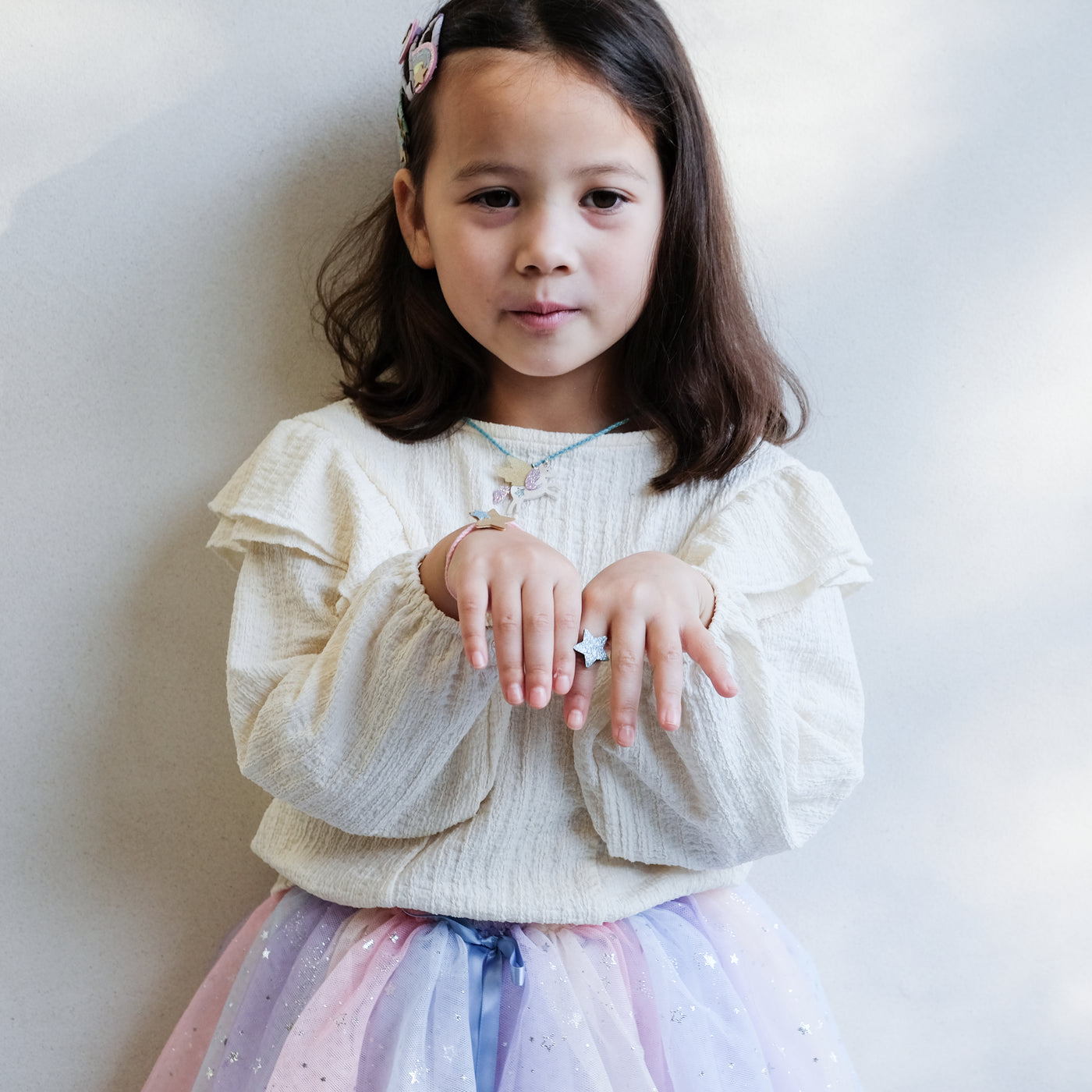 girl wearing flying unicorn jewellery set