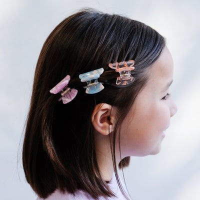 girl wearing mixed acetate claw clips in hair