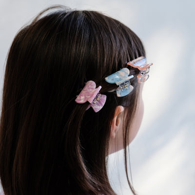 girl wearing mixed acetate claw clips in hair