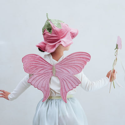 Child wearing a full flower fairy dress up set including velvet wings, velvet hat with stalk, soft green tutu and flower wand with ribbon trails