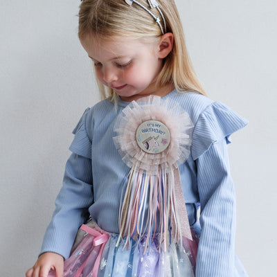 video of little girl wearing a mimi and lula unicorn birthday badge