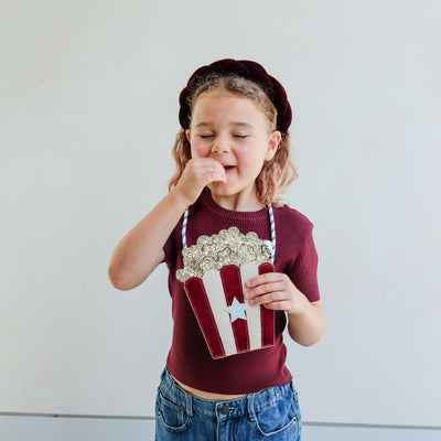 video of girl wearing popcorn bag pretending to eat popcorn