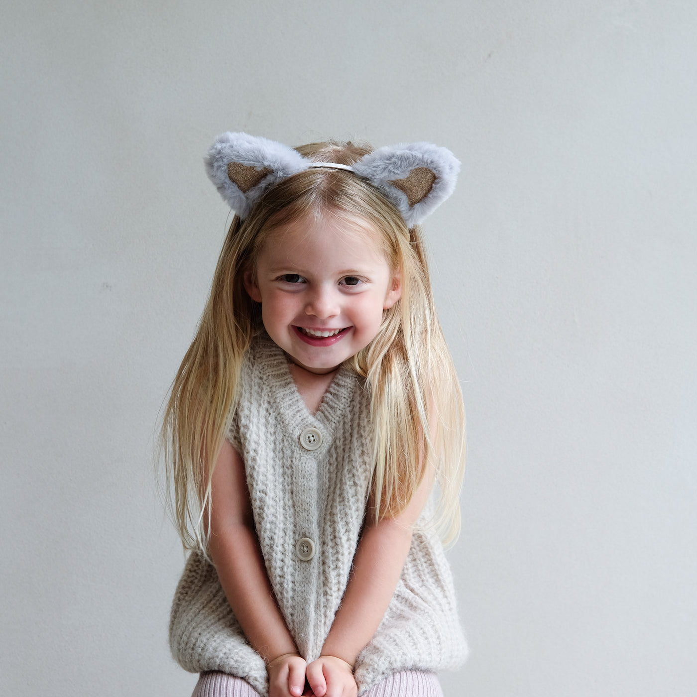 young girl wearing fluffy cat ears headband