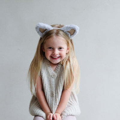 young girl wearing fluffy cat ears headband