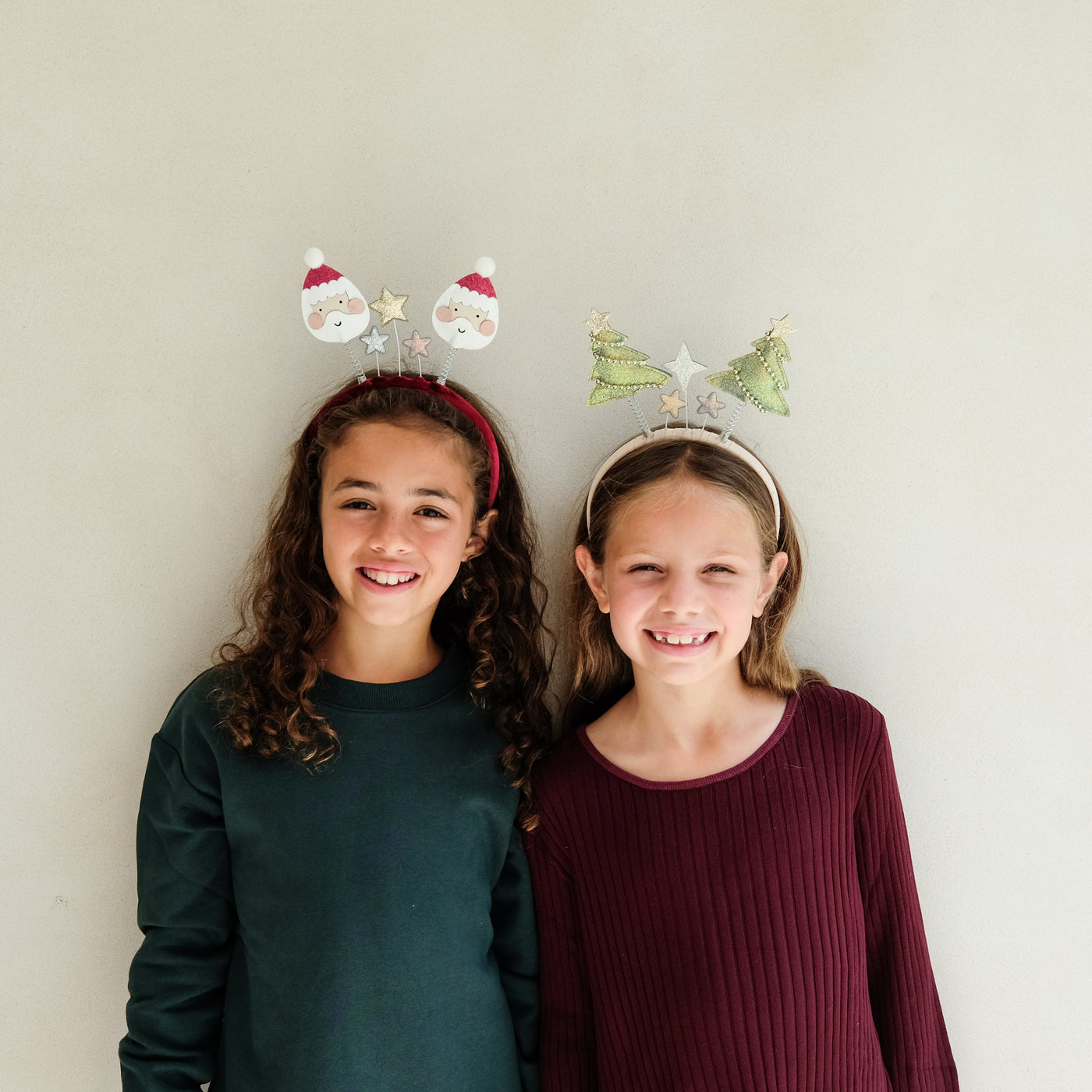 Video of two girls wearing Christmas headband boppers