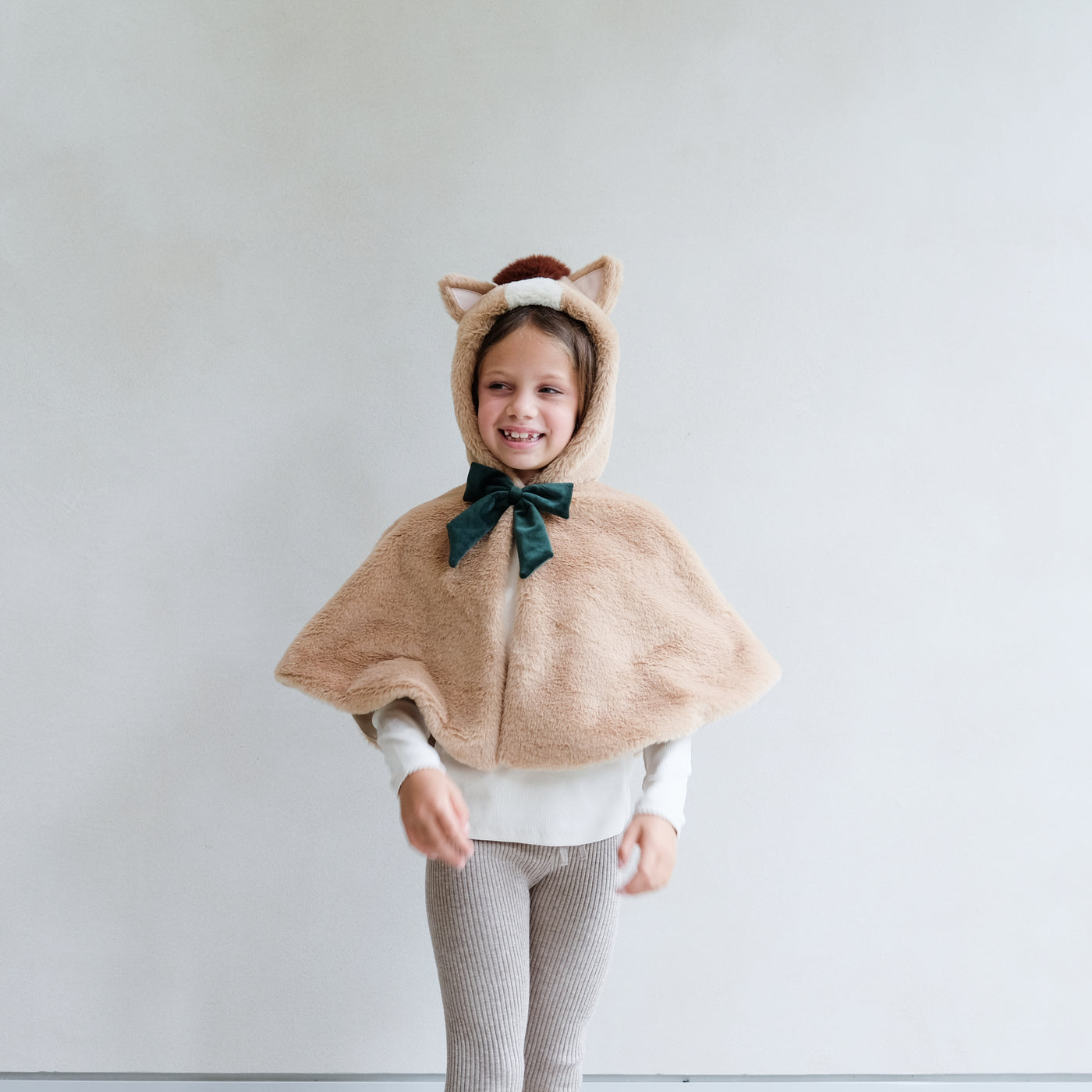 girl wearing horse dress up cape