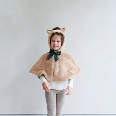 girl wearing horse dress up cape