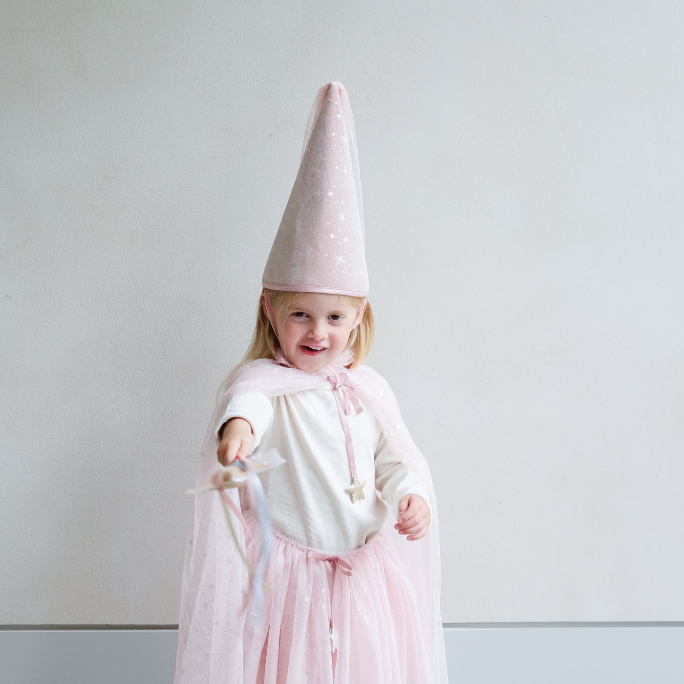 Video of a girl wearing shimmer pink princess cape, crown, tutu, and wand