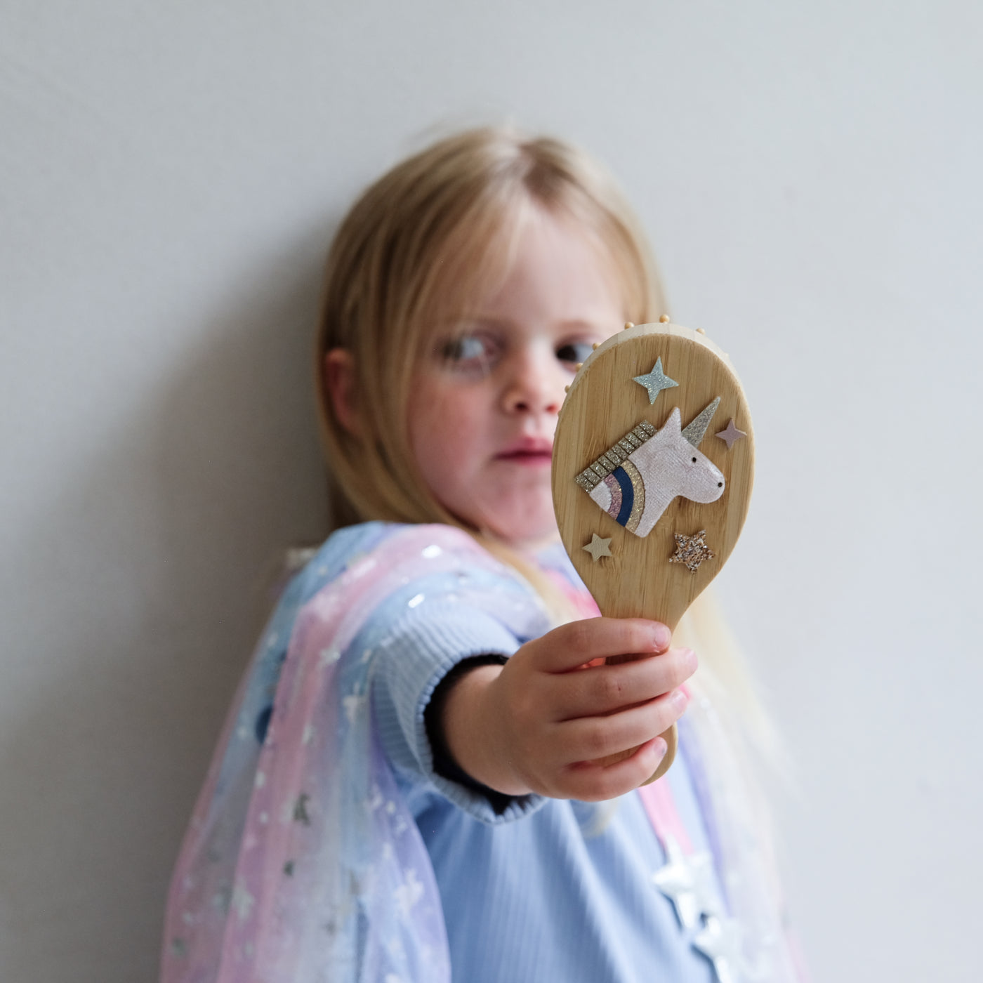 Video of girl using unicorn hair brush