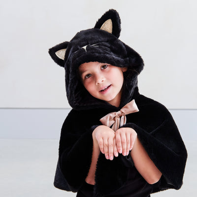 Video of a young girl wearing a fluffy black cat cape