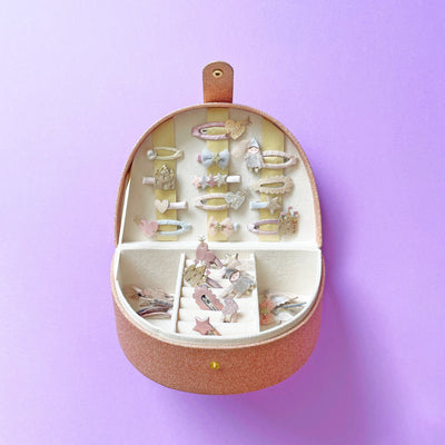Neutral Rainbow Jewellery Box with hair accessories inside against a purple background